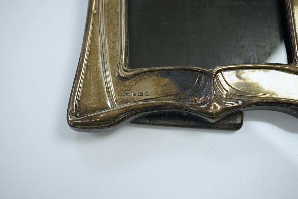 An Edwardian Art Nouveau silver mounted photograph frame, Henry Matthews, Birmingham 1904, 20.6cm. Condition - poor